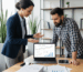 Professional SEO consultant explaining local search analytics to small business owner in modern office