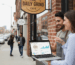 Professional local SEO consultant assisting small business owner during on-site consultation in vibrant neighborhood