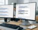 Modern office desk with two monitors showing Google search results and a People Also Ask box, smartphone with Google Maps beside keyboard, emphasizing local SEO and AI-driven solutions.