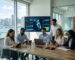 Diverse business team in modern Miami office reviewing local SEO dashboard with Florida map on large monitor