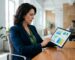 Professional photograph of a business owner reviewing a competitive cost analysis on a tablet in a modern office setting