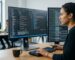 Developer working on website configuration on dual monitors in a clean office