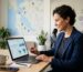 Small business owner reviewing conversion rate optimization dashboards on laptop in modern office