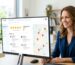Smiling business owner viewing a Google Business Profile dashboard with star ratings and a map on a desktop monitor in a bright office